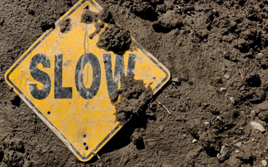 yellow slow caution sign in dirt reminding to dance the slow steps